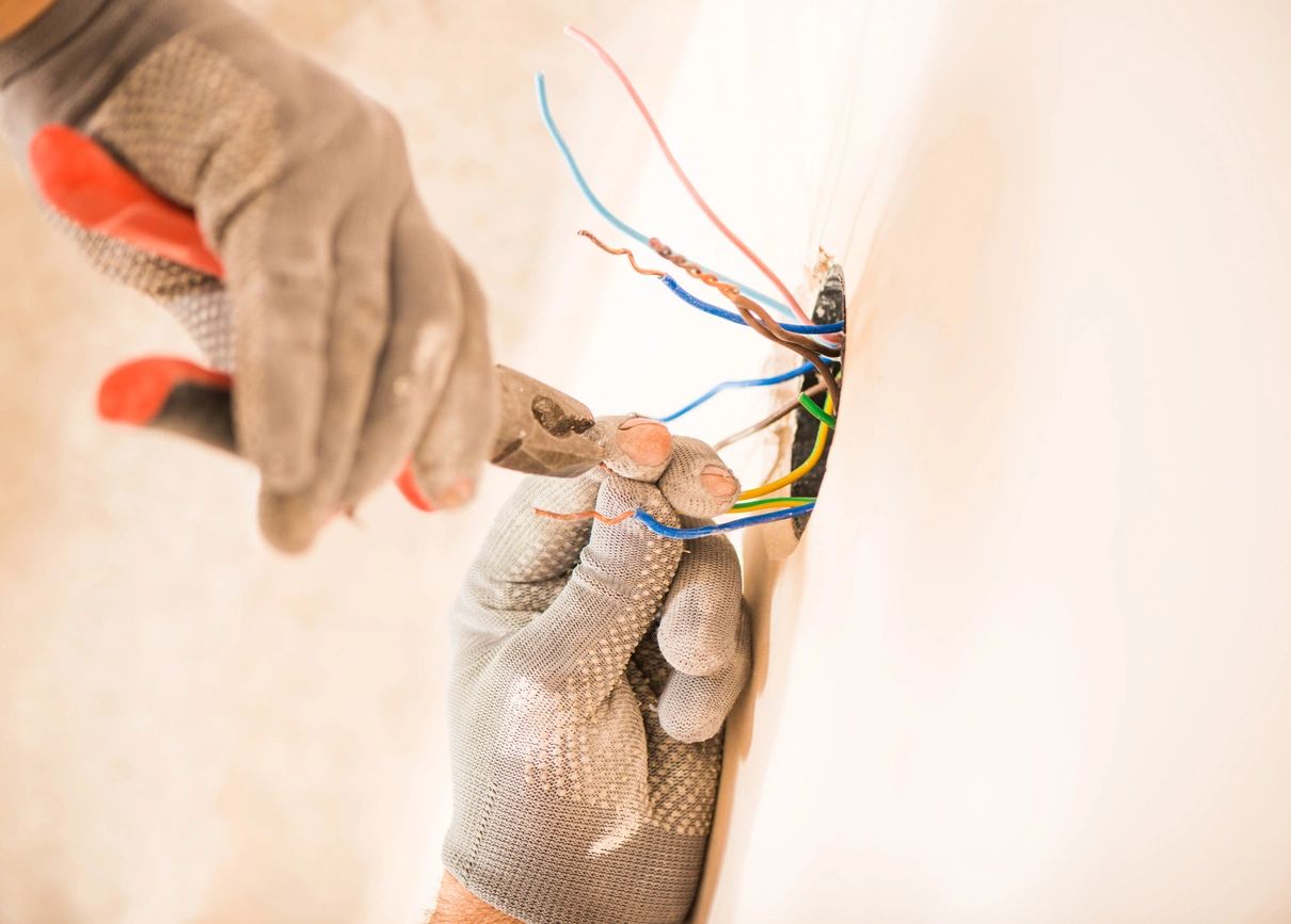 A Spokane electrician rewiring an electrical device